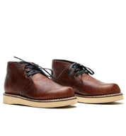 A pair of brown leather lace-up Santa Rosa Brand Union Cognac Bison boots, with a light-colored Vibram 2021 wedge outsole, isolated on a white background.
