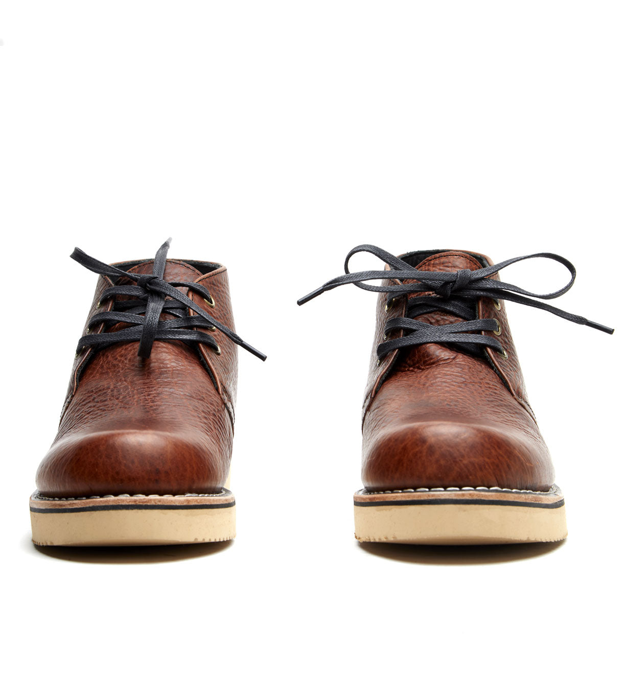 A pair of brown leather Santa Rosa Brand Union Cognac Bison Boots with black laces and a Vibram 2021 wedge outsole, on a white background.