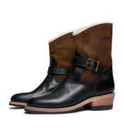 A pair of Santa Rosa Brand Carson Harness Boots in black and brown full grain leather with buckle detail.