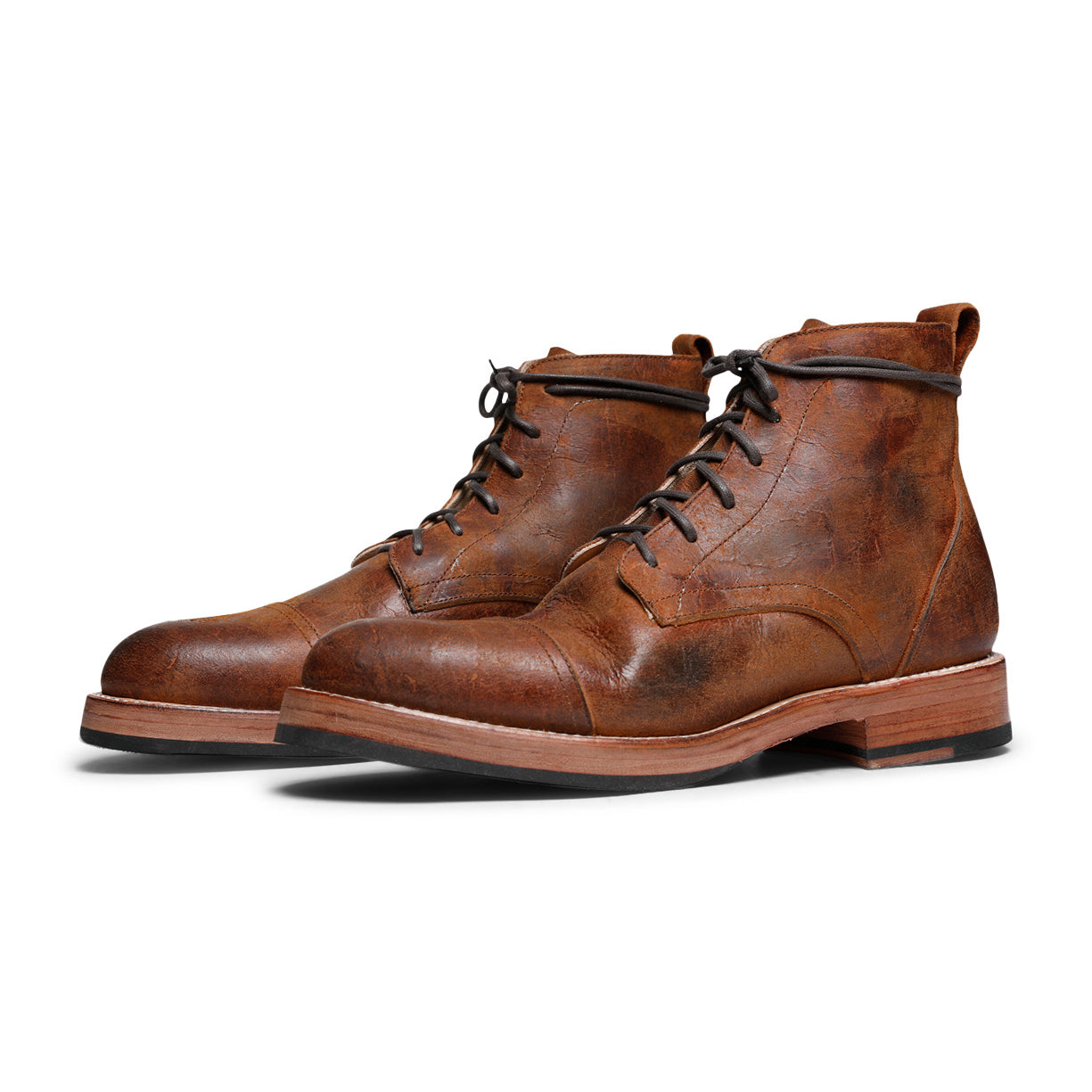 A pair of Larry Boot brown leather boots from Santa Rosa Brand with vegetable tanned lining on a white background.