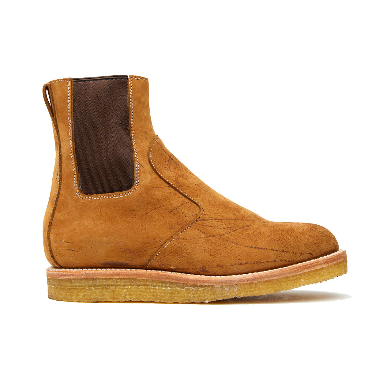 The Santa Rosa Brand Stamford Boot, made of veg tan leather, features a tan sued chelsea design on a white background. With its natural crepe outsole, this boot adds both style and comfort to.