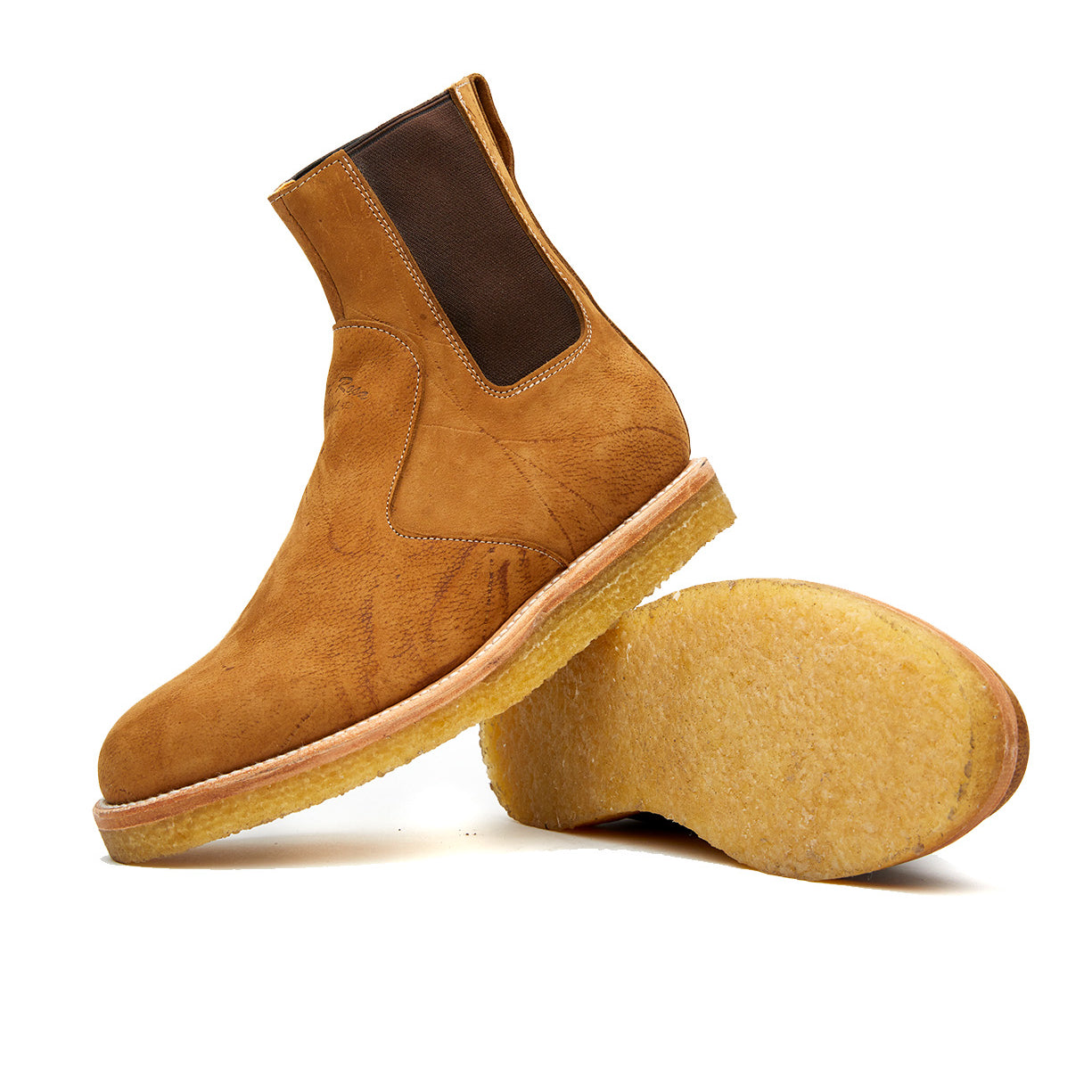 A pair of Santa Rosa Brand Stamford Boot Peanut Kudu Chelsea boots against a white background with a natural crepe outsole.