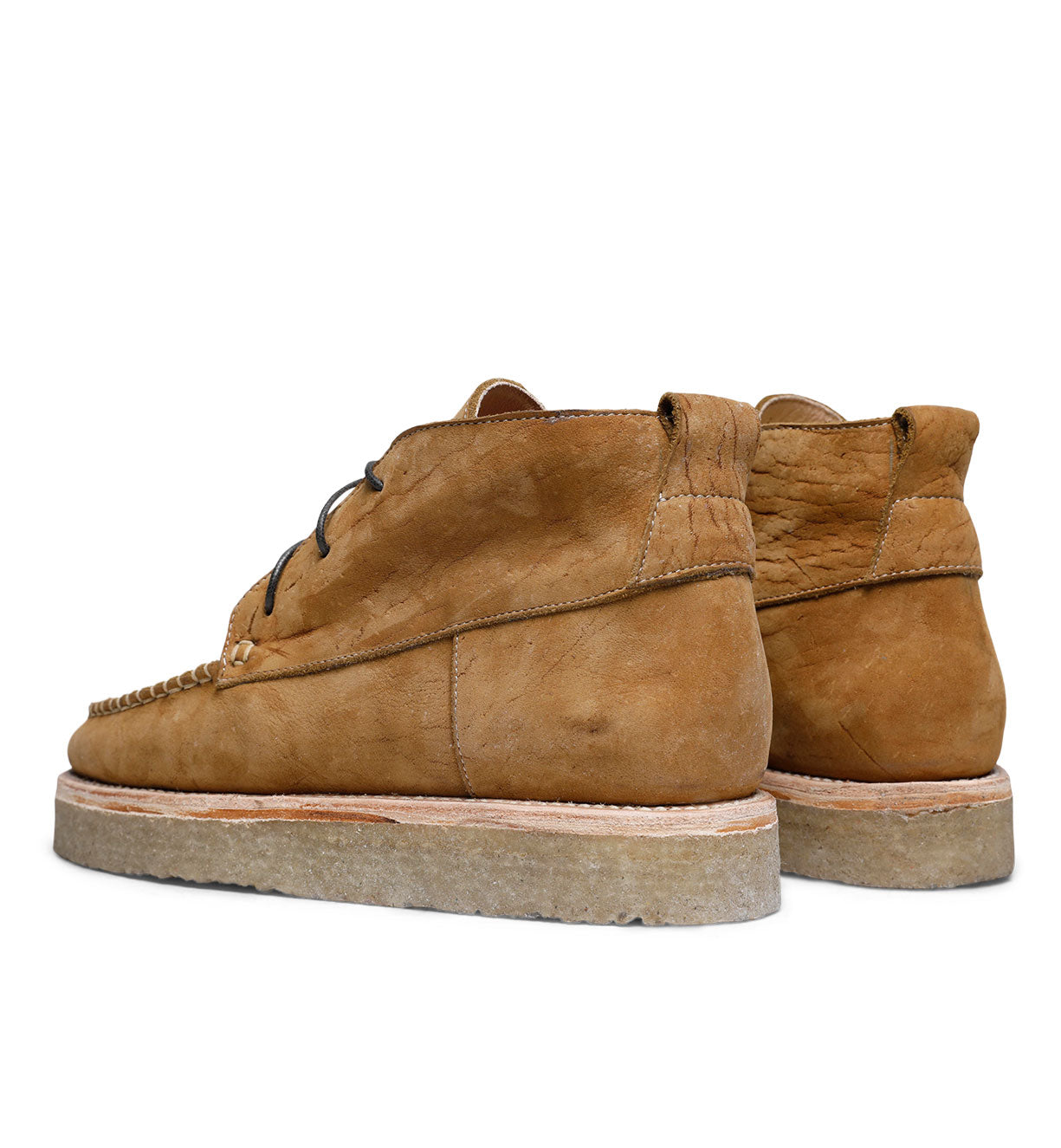 A pair of worn Santa Rosa Brand Tahoma Moccasin boots in brown suede against a white background.